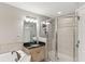 This bathroom features a tiled shower with glass doors, a vanity with granite counters and neutral tones at 684 Bayway Blvd, Clearwater, FL 33767