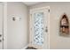 Charming entryway with decorative glass door, boat shelf, and nautical decor at 684 Bayway Blvd, Clearwater, FL 33767