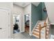 Hallway near stairs features blue accent wall, leading to bathroom and bedroom at 684 Bayway Blvd, Clearwater, FL 33767