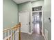 Hallway featuring gray tile flooring, leading to the bright, open living area at 684 Bayway Blvd, Clearwater, FL 33767