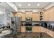 Spacious kitchen featuring stainless steel appliances, granite countertops, and custom wood cabinets at 684 Bayway Blvd, Clearwater, FL 33767