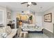 Bright living room open to the kitchen and staircase, with bar seating and tile floors at 684 Bayway Blvd, Clearwater, FL 33767