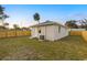 Large backyard with a wooden fence and grassy area at 701 E Wood St, Tampa, FL 33604