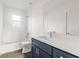 Clean bathroom with a white vanity, a shower/tub combo, and dark blue cabinetry at 701 E Wood St, Tampa, FL 33604