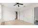 Bedroom with hardwood floors, ceiling fan and bathroom access at 701 E Wood St, Tampa, FL 33604