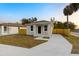 Newly built house with gray siding, a small front yard, and a concrete driveway at 701 E Wood St, Tampa, FL 33604