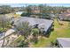 Aerial view of home featuring lush landscaping, mature trees, and water views from the backyard at 7161 Fairway Bend Cir, Sarasota, FL 34243