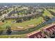 Scenic aerial shot of a golf course community with ponds and lush green fairways at 7161 Fairway Bend Cir, Sarasota, FL 34243