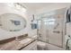 Bathroom with granite countertop, framed mirror, and glass enclosed shower at 7161 Fairway Bend Cir, Sarasota, FL 34243