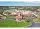 Stunning aerial view of a golf clubhouse and a well-manicured golf course at 7161 Fairway Bend Cir, Sarasota, FL 34243