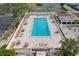 Aerial view of a sparkling swimming pool with lounge chairs and umbrellas at 7161 Fairway Bend Cir, Sarasota, FL 34243