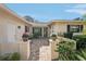 A welcoming entryway with a brick porch, potted flowers, and a serene atmosphere at 7161 Fairway Bend Cir, Sarasota, FL 34243