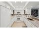 Well-lit kitchen with white cabinetry, granite counters, and an open layout to dining area at 7161 Fairway Bend Cir, Sarasota, FL 34243