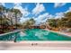 A refreshing pool reflects the sky and trees at 7161 Fairway Bend Cir, Sarasota, FL 34243