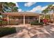 The pool house has screened-in areas and is surrounded by lush landscaping at 7161 Fairway Bend Cir, Sarasota, FL 34243