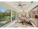 Bright sunroom with multiple ceiling fans and sliding glass doors opening to the backyard at 7161 Fairway Bend Cir, Sarasota, FL 34243