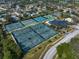 Aerial view of a tennis center featuring multiple tennis courts at 7501 Cumberland Rd # 22, Seminole, FL 33777