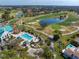 Aerial view of neighborhood clubhouse, pool, golf course and surrounding residences at 7501 Cumberland Rd # 22, Seminole, FL 33777