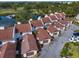 Aerial shot shows roof detail, attached garage, and proximity to the water in this well-maintained townhome community at 7501 Cumberland Rd # 22, Seminole, FL 33777