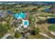 Aerial view of clubhouse, pool, golf course, and surrounding neighborhood at 7501 Cumberland Rd # 22, Seminole, FL 33777