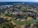 Scenic aerial view of a golf course community with ponds and residential area, offering a picturesque landscape at 7501 Cumberland Rd # 22, Seminole, FL 33777