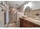 Beautiful bathroom with tiled shower, wood cabinets, stone sink, and elegant fixtures at 7501 Cumberland Rd # 22, Seminole, FL 33777