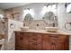 Bathroom with a wooden vanity, dual sinks, and bronze fixtures at 7501 Cumberland Rd # 22, Seminole, FL 33777