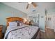 Well-lit bedroom featuring a mirrored closet, ceiling fan, and light green walls at 7501 Cumberland Rd # 22, Seminole, FL 33777