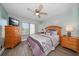 Inviting bedroom with a decorative ceiling fan, soft color palette, and comfortable furnishings at 7501 Cumberland Rd # 22, Seminole, FL 33777