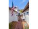 Inviting gated entrance with a brick walkway leading to a charming home adorned with an American flag at 7501 Cumberland Rd # 22, Seminole, FL 33777