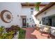 Inviting patio area with brick flooring, outdoor seating, decorative accents, and a charming front entrance at 7501 Cumberland Rd # 22, Seminole, FL 33777