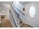 Bright entryway with staircase featuring stylish carpet pattern, leading to a modern living space at 7501 Cumberland Rd # 22, Seminole, FL 33777