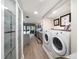 Laundry room leading to kitchen showcases side-by-side washer and dryer at 7501 Cumberland Rd # 22, Seminole, FL 33777