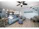 Bright living room featuring a blue leather sofa and view of the modern kitchen at 7501 Cumberland Rd # 22, Seminole, FL 33777