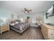 Bright main bedroom featuring hardwood floors, a ceiling fan, and neutral paint at 7501 Cumberland Rd # 22, Seminole, FL 33777