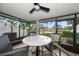 Enclosed patio featuring a ceiling fan, and view of the lush landscaped yard and pond at 7501 Cumberland Rd # 22, Seminole, FL 33777