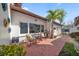 Inviting patio area with brick flooring, outdoor seating, a grill, and a view of lush greenery at 7501 Cumberland Rd # 22, Seminole, FL 33777