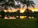 Serene view of a pond reflecting a stunning sunset, showcasing the beauty of the natural surroundings at 7501 Cumberland Rd # 22, Seminole, FL 33777