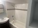 Bathroom with white tiled shower/tub combo at 8004 N 11Th St, Tampa, FL 33604