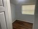 Small bedroom with hardwood floors and window at 8004 N 11Th St, Tampa, FL 33604