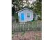 Gray house with blue door, picket fence, and small yard at 8004 N 11Th St, Tampa, FL 33604