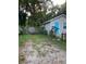 Side view showing gray house, yard, and fence at 8004 N 11Th St, Tampa, FL 33604