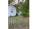 Side view showing gray house, yard, and fence at 8004 N 11Th St, Tampa, FL 33604