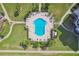 Aerial view of community pool with manicured landscaping, lounge chairs, and walkways at 8040 Sailboat Key S Blvd # 304, St Pete Beach, FL 33707