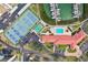 Aerial view of tennis courts, a pool, and a marina, providing diverse recreational options at 8040 Sailboat Key S Blvd # 304, St Pete Beach, FL 33707