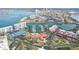 Scenic aerial view of a waterfront community with condos, a marina, and tennis courts at 8040 Sailboat Key S Blvd # 304, St Pete Beach, FL 33707