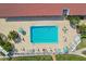 Aerial shot showcasing the community pool with lounge seating and tropical landscaping at 8040 Sailboat Key S Blvd # 304, St Pete Beach, FL 33707