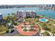 Aerial view of waterfront condominium complex with lush landscaping and pool at 8040 Sailboat Key S Blvd # 304, St Pete Beach, FL 33707