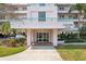 Inviting building entrance with well-manicured landscaping creating a serene and welcoming ambiance at 8040 Sailboat Key S Blvd # 304, St Pete Beach, FL 33707