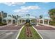 Elegant community entrance with meticulously maintained landscaping and decorative archways offering a warm welcome at 8040 Sailboat Key S Blvd # 304, St Pete Beach, FL 33707